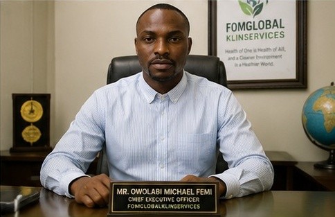 Owolabi Michael Femi, CEO of FOMGLOBAL KLINSERVICES, at his desk